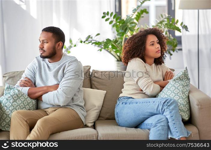 relationship difficulties, conflict and people concept - unhappy african american couple having argument at home. unhappy couple having argument at home