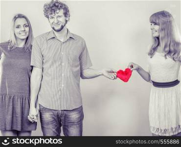 Relationships and feelings in triangle. Happy relationship of three people. Two women having one man. Forbidden love concept.. Happy triangle relationship