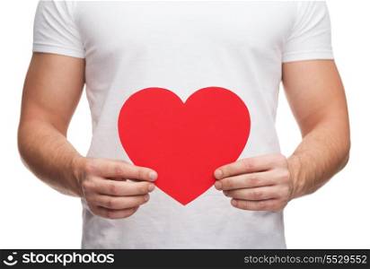 relationships and love concept - closeup of man hands with heart