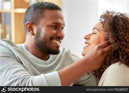 relationships and people concept - happy african american couple at home. happy african american couple at home