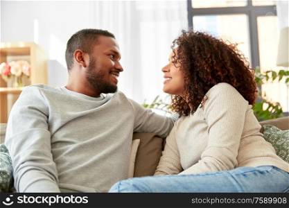 relationships and people concept - happy african american couple at home. happy african american couple at home