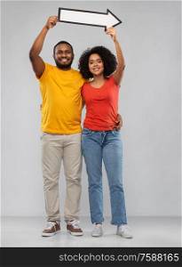 relationships and people concept - happy african american couple holding big white rightwards thick arrow over grey background. happy african american couple holding arrow