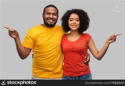 relationships and people concept - happy african american couple over grey background. happy african american couple
