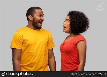 relationships and people concept - happy excited african american couple over grey background. happy excited african american couple