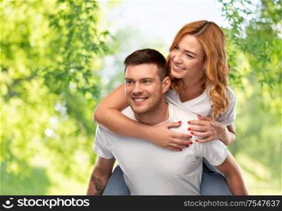 relationships and people concept - portrait of happy couple in white t-shirts having fun over green natural background. happy couple in white t-shirts having fun