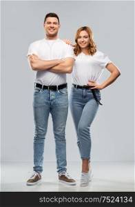 relationships and people concept - portrait of happy couple in white t-shirts over grey background. portrait of happy couple in white t-shirts