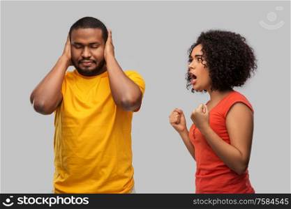 relationships and people concept - unhappy african american couple having argument over grey background. african american couple having argument