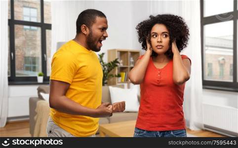 relationships and people concept - unhappy african american couple having argument over home background. african american couple having argument at home