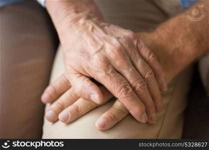 relationships, charity, old age and people concept - close up of senior couple holding hands. close up of senior couple holding hands