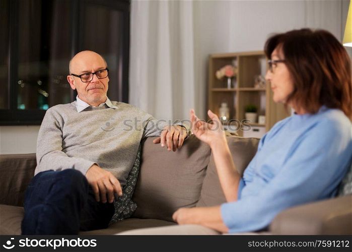 relationships difficulties, communication and people concept - unhappy senior couple arguing or discussing problem at home. unhappy senior couple arguing at home