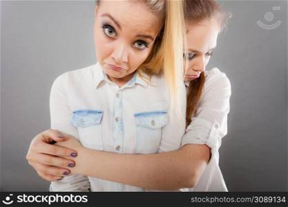 Relationships, friendship concept. Girl hugging her sad friend. Girl hugging her sad friend