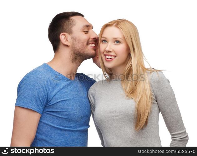 relationships, love and couple concept - smiling boyfriend telling girlfriend secret