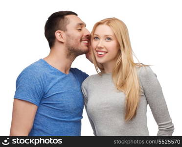relationships, love and couple concept - smiling boyfriend telling girlfriend secret