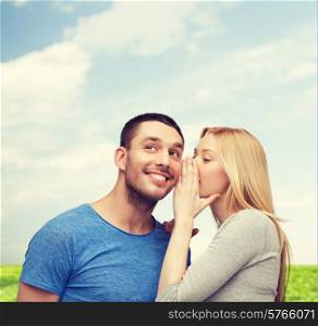 relationships, love and couple concept - smiling girlfriend telling boyfriend secret