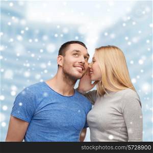 relationships, love, people, information and couple concept - smiling girlfriend telling boyfriend secret over snow and city buildings background