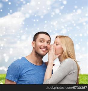 relationships, love, people, information and couple concept - smiling girlfriend telling boyfriend secret over blue sky with snow and grass background