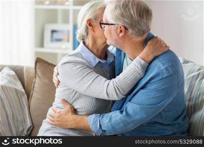 relationships, old age and people concept - close up of happy senior couple hugging and kissing at home. close up of happy senior couple hugging at home