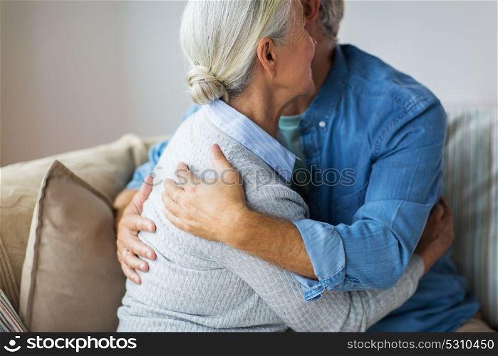 relationships, old age and people concept - close up of happy senior couple hugging at home. close up of happy senior couple hugging at home