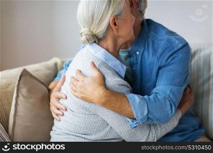 relationships, old age and people concept - close up of happy senior couple hugging at home. close up of happy senior couple hugging at home