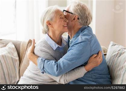relationships, old age and people concept - happy senior couple hugging at home. happy senior couple hugging at home