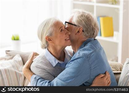 relationships, old age and people concept - happy senior couple hugging at home. happy senior couple hugging at home