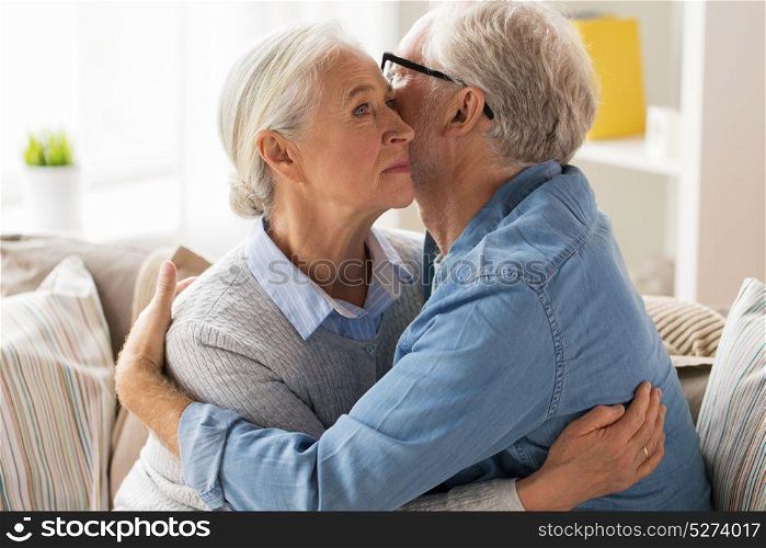 relationships, old age and people concept - sad senior couple hugging at home. sad senior couple hugging at home