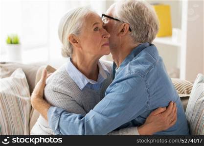 relationships, old age and people concept - sad senior couple hugging at home. sad senior couple hugging at home