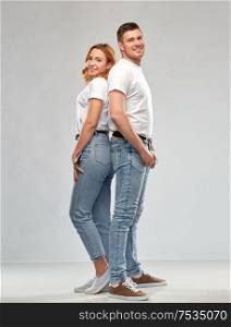 relationships, style and people concept - portrait of happy couple in white t-shirts over grey background. portrait of happy couple in white t-shirts