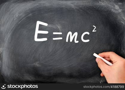 Relativity formula E=mc2 written on a Blackboard background