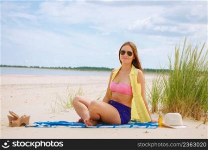 Relax and≤isure. Young woman resting on∑mer beach. Pretty girl sunbathing on fresh air in∑mer.. Woman resting on beach.