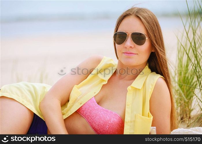 Relax and leisure. Young woman resting on summer beach. Pretty girl sunbathing on fresh air in summer.. Woman resting on beach.