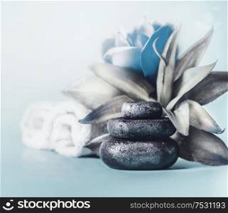 Relax day. Chill out and calm down concept. Stack of zen stones with blue flowers and towels. Wellness Therapy. Spa setting