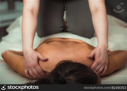 Relax massage for shoulders, hands of a massage therapist massaging shoulder of a female client
