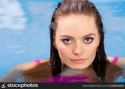 Relax, spa hotel, resort concept. Charming woman having fun in swimming pool, relaxing enjoying the water. Woman having fun in swimming pool