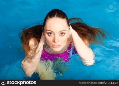 Relax, spa hotel, resort concept. Charming woman having fun in swimming pool, relaxing enjoying the water. Woman having fun in swimming pool