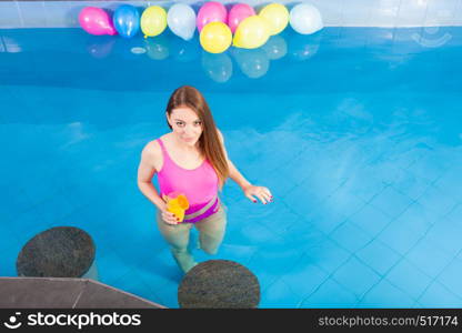 Relax, spa wellness concept. Charming woman having fun with cocktail drink alcohol. Pretty girl relaxing at swimming pool, enjoying the water. Girl with cocktail drink relaxing at swimming pool