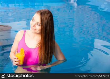 Relax, spa wellness concept. Charming woman having fun with cocktail drink alcohol. Pretty girl relaxing at swimming pool, enjoying the water. Girl relaxing at swimming pool with drink