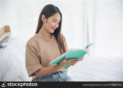 Relax woman holding book read at bookshelf in university library. Young woman relaxation reading open book leisure mind. Smart beautiful woman clever person in knowledge intellectual learning center