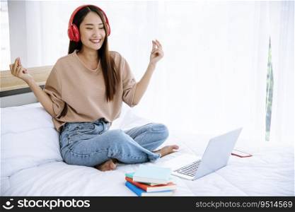 Relax woman holding book read on bed using headphone listen music. Young woman relaxation reading open book leisure mind. Happiness beautiful woman person