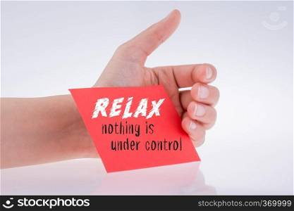 Relax wording written on red paper in hand