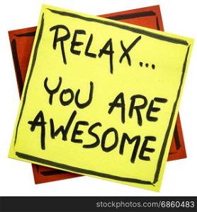 Relax, you are awesome - reminder or positive affirmation - handwriting on an isolated sticky note