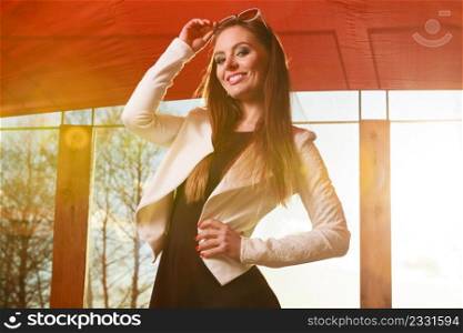 Relaxation having fun concept. Beautiful girl during sunny day. Fashionable long hair female elegant clothing posing indoors. Young woman having fun on sunny day.