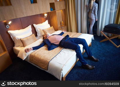 relaxed and happy young couple in modern hotel room