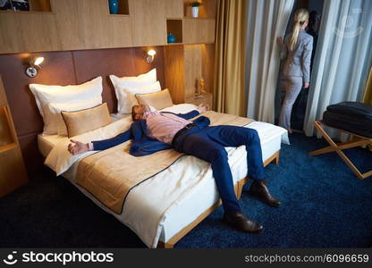 relaxed and happy young couple in modern hotel room