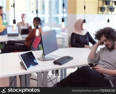 relaxed businessman as startup entrepreneur working on desktop computer in modern open space coworking office
