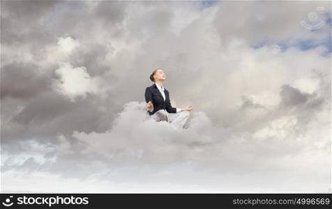 Relaxed businesswoman. Young attractive lady sitting on cloud and practicing yoga