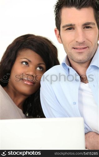 Relaxed couple in front of laptop