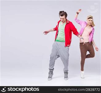 Relaxed couple of attractive teenager in dance pose