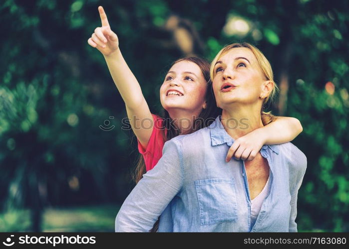 Relaxed happy mother and little kid daughter in outdoors public park. Parenthood and child concept.