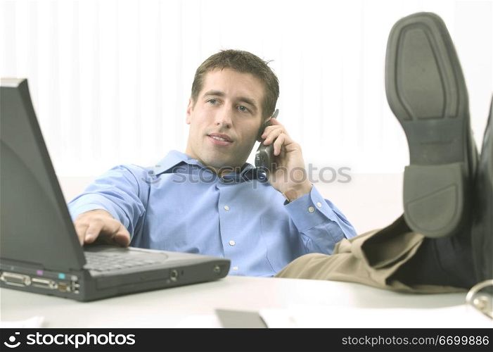 Relaxed Man in Blue Shirt with Laptop